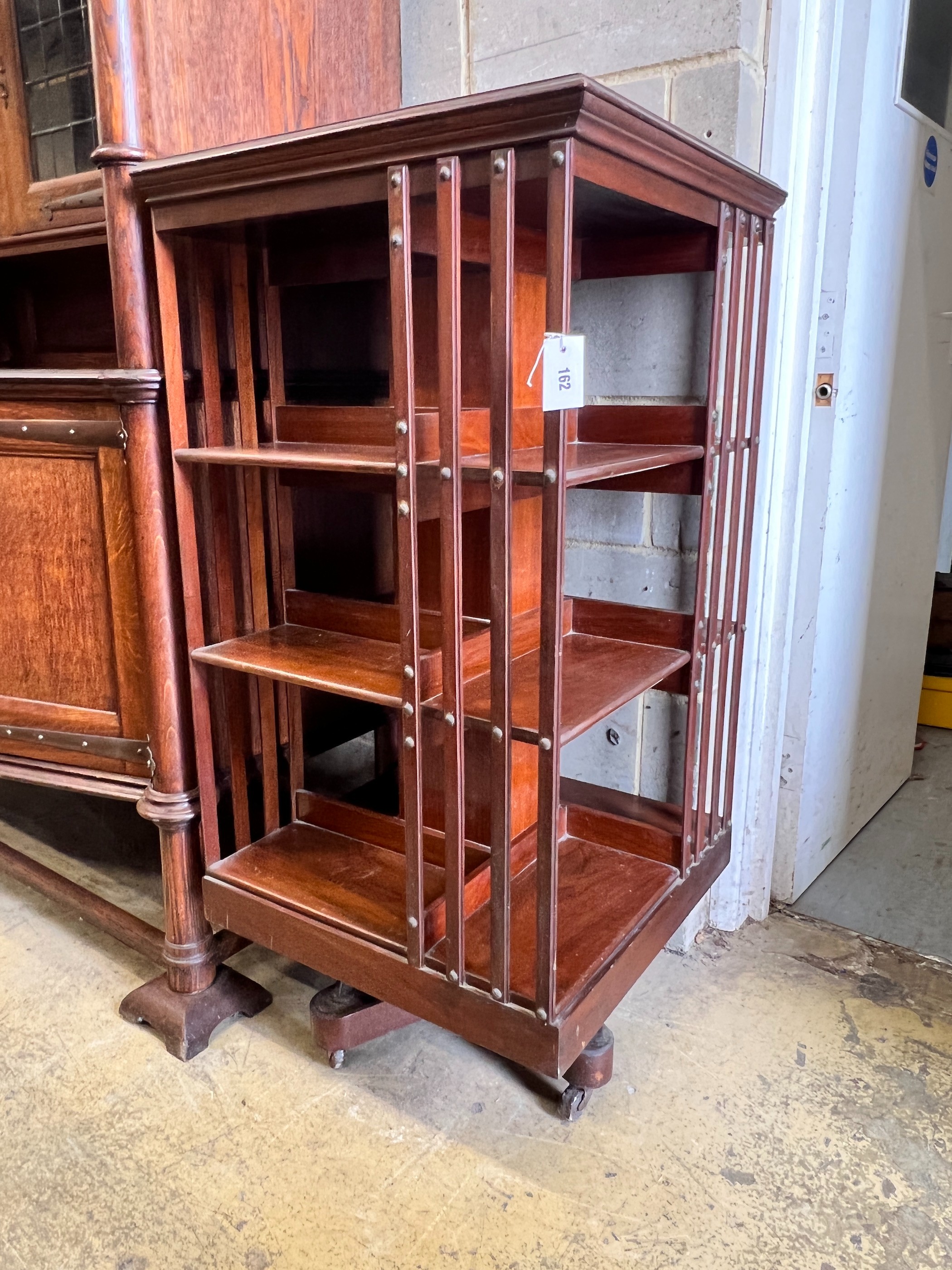 An Edwardian walnut revolving bookcase, width 60cm, height 120cm